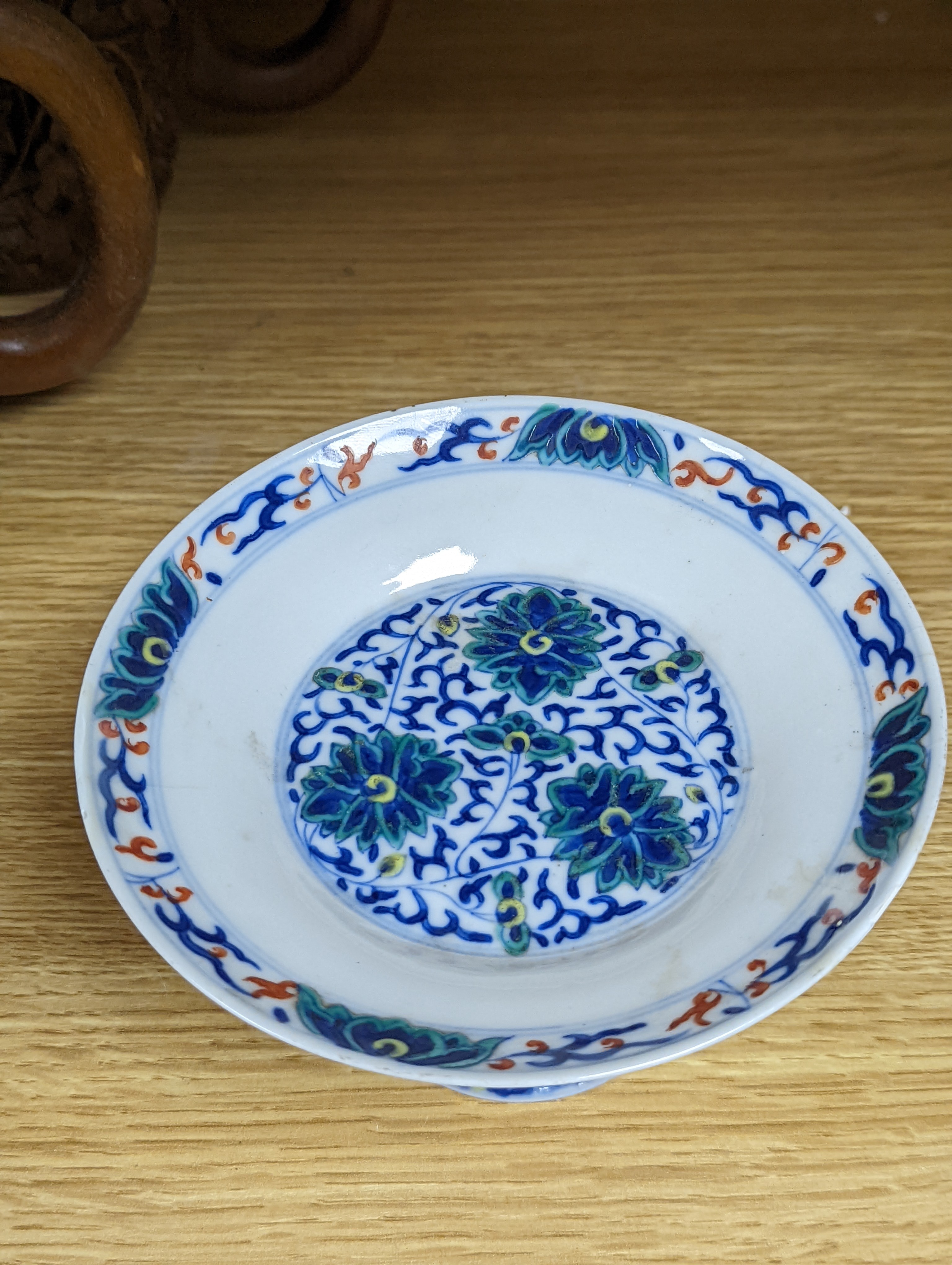 A Chinese blue and white water pipe vessel, a doucai stem dish and a Japanese Imari bowl, 19th century, (3)